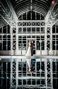 Reflection of bride and groom in swimming pool