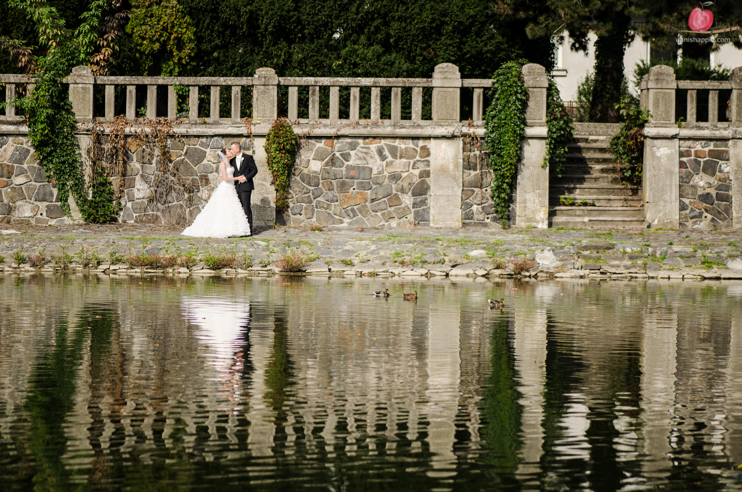 photo of bride and groom across a riverbank